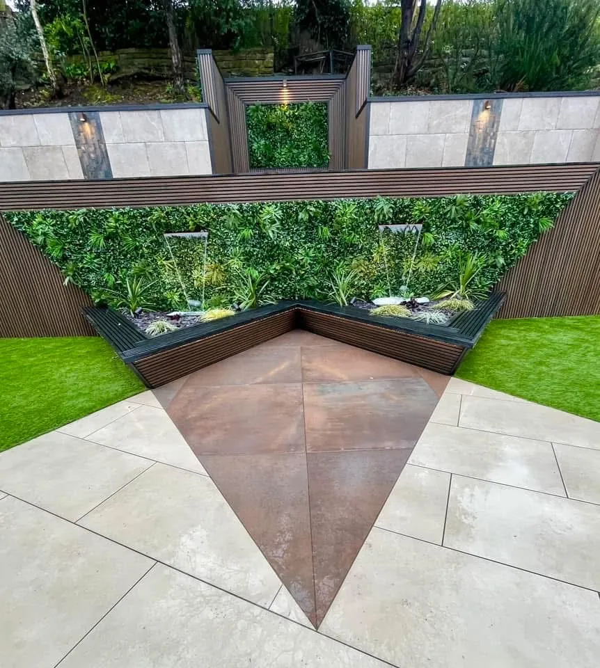 Corten steel feature set into porcelain paving in front of a living wall