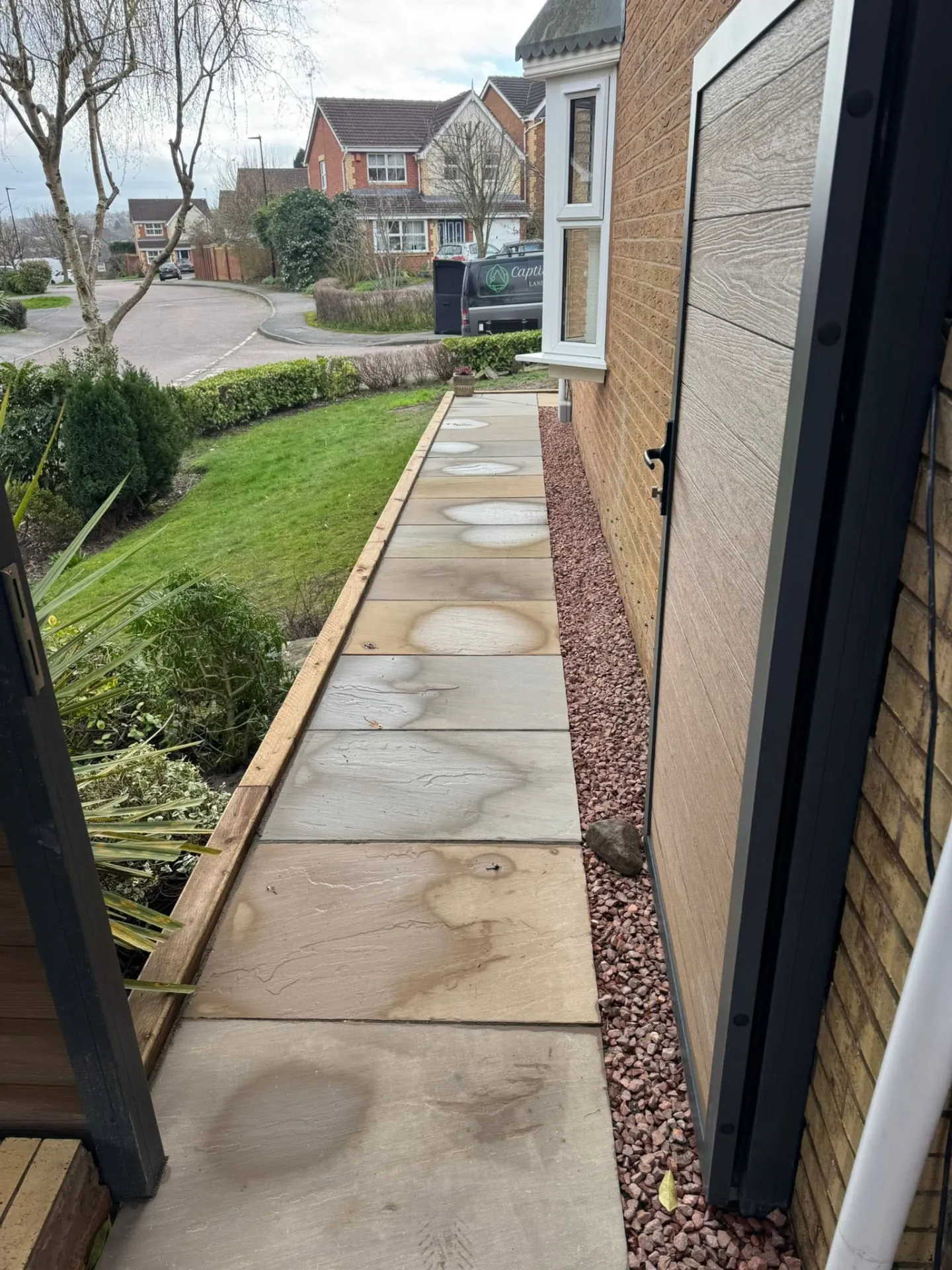Sandstone side path laid along a house wall