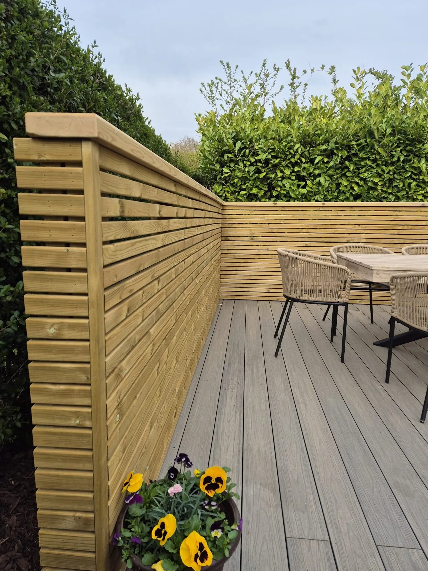 Timber-look decking beside a horizontal slatted privacy screen