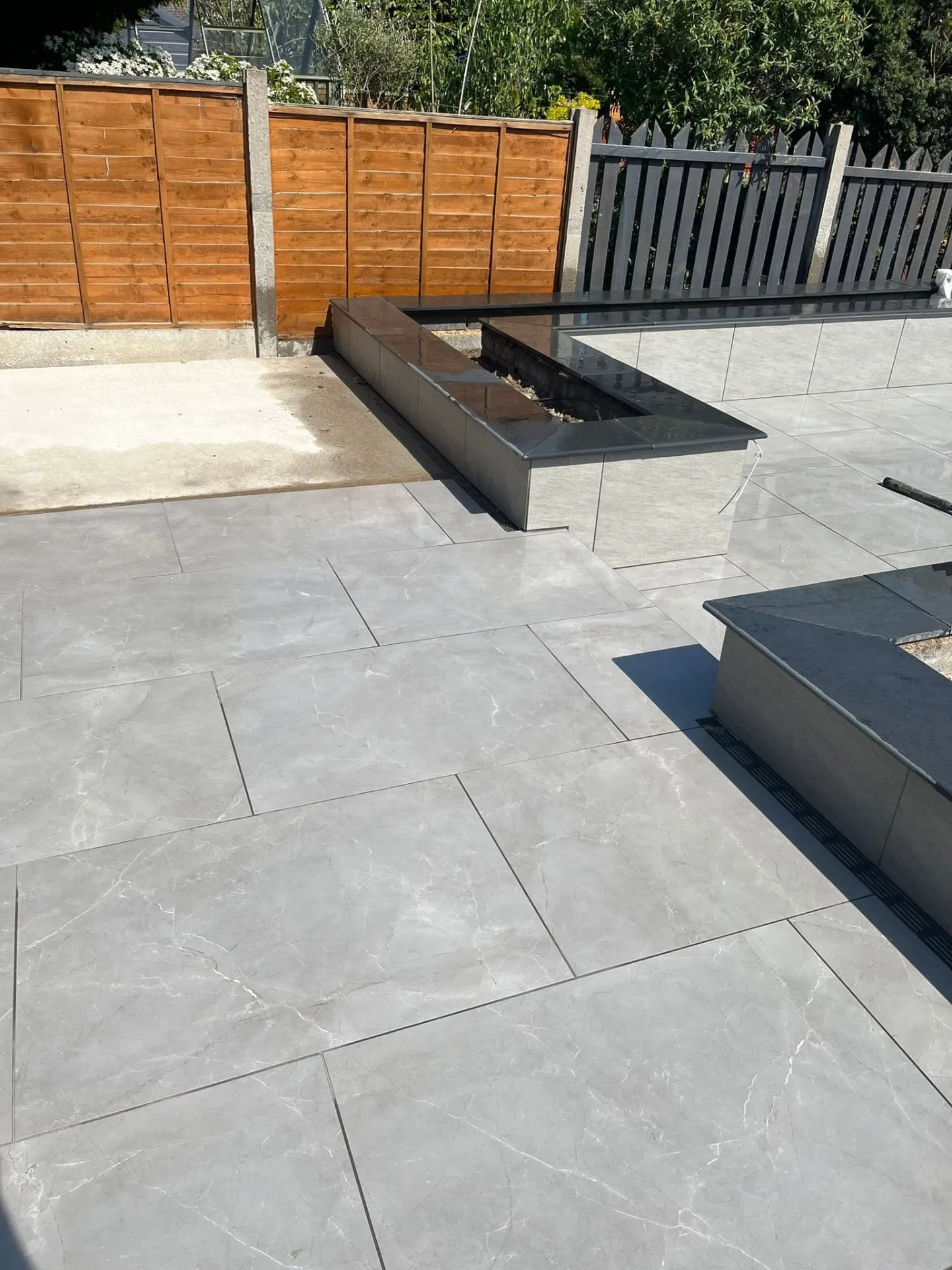 Raised planters being finished on a new porcelain patio