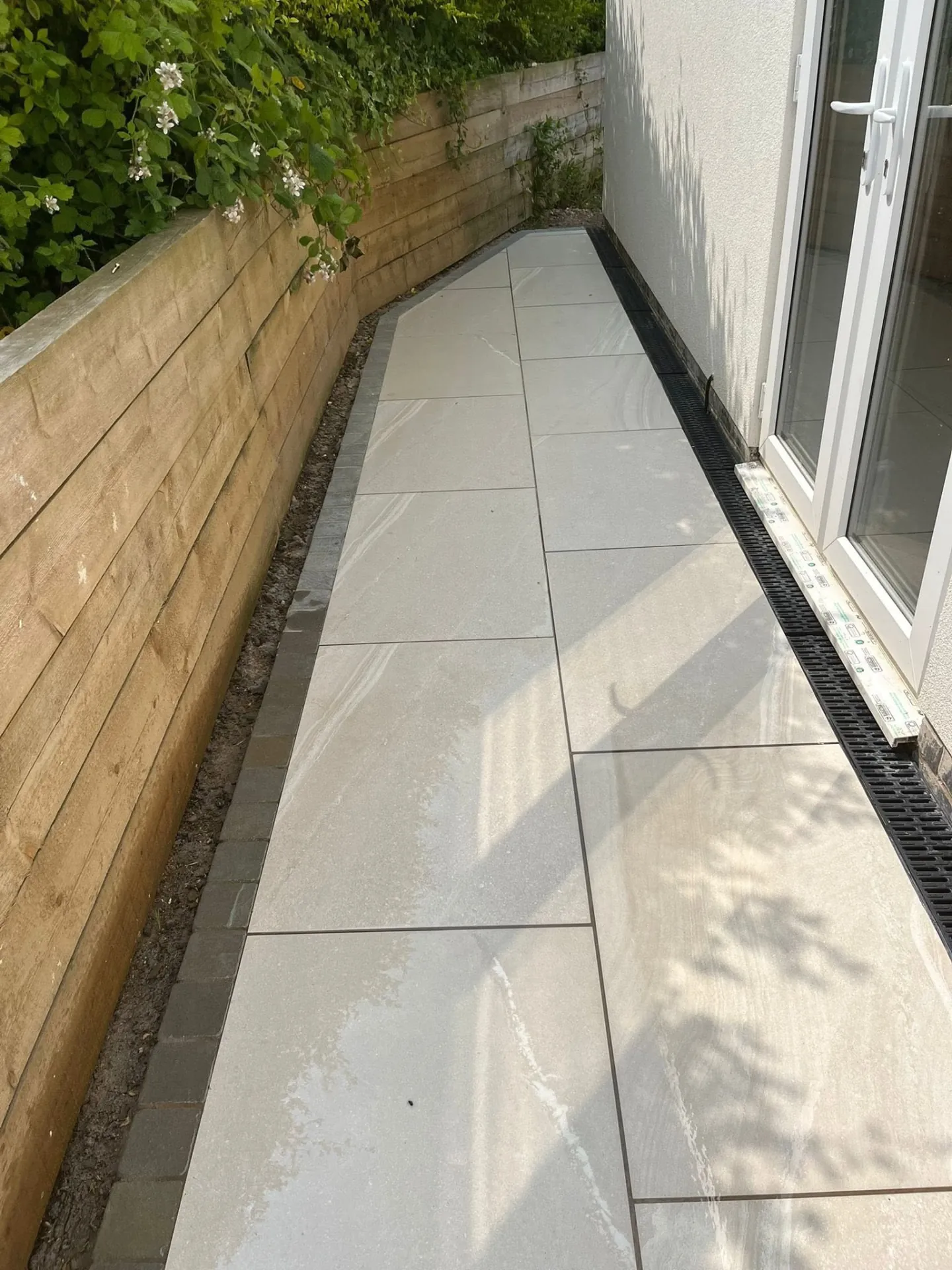 Pale paved side path with linear drainage channel