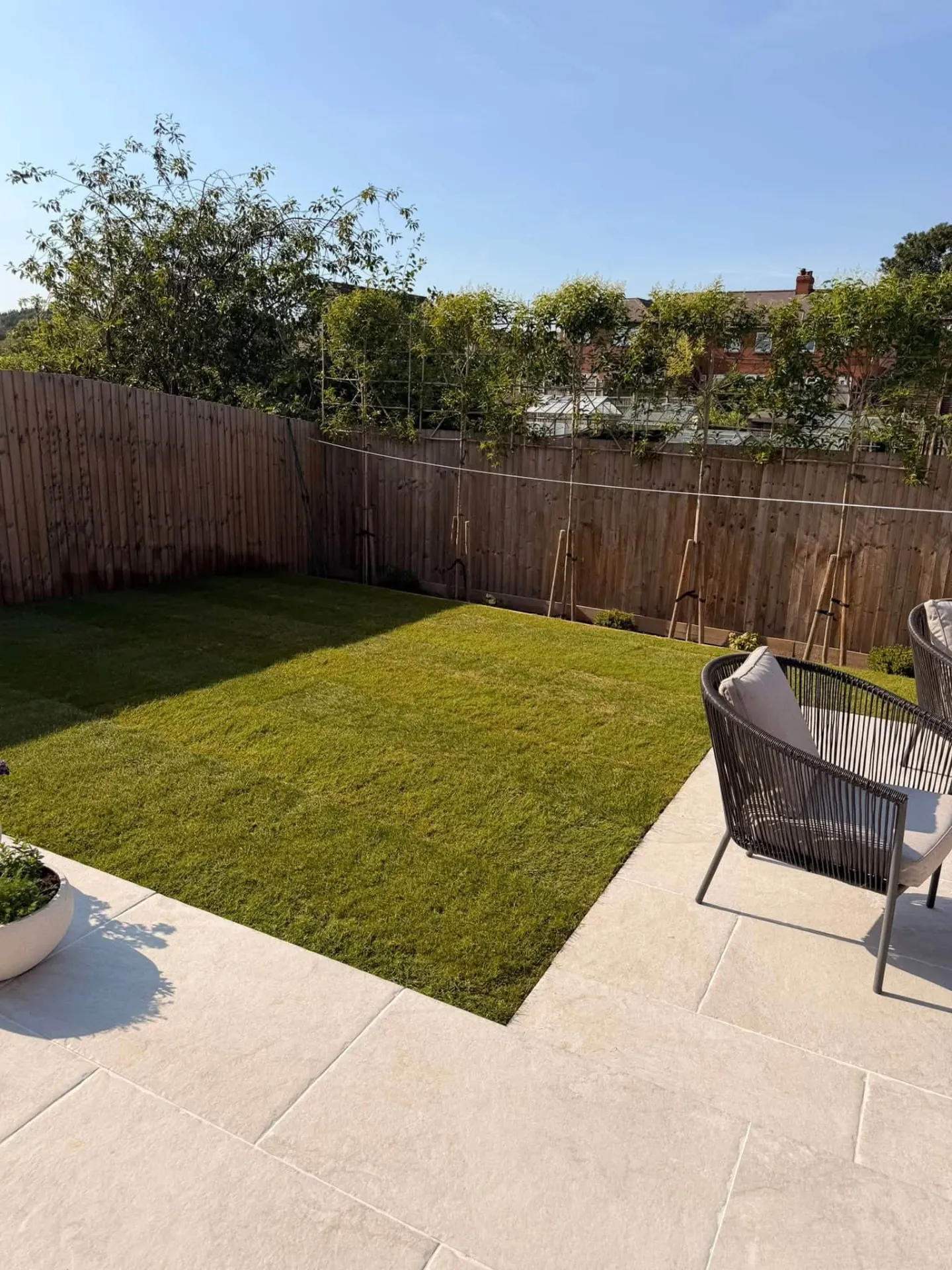 Natural lawn with pale paving after turfing