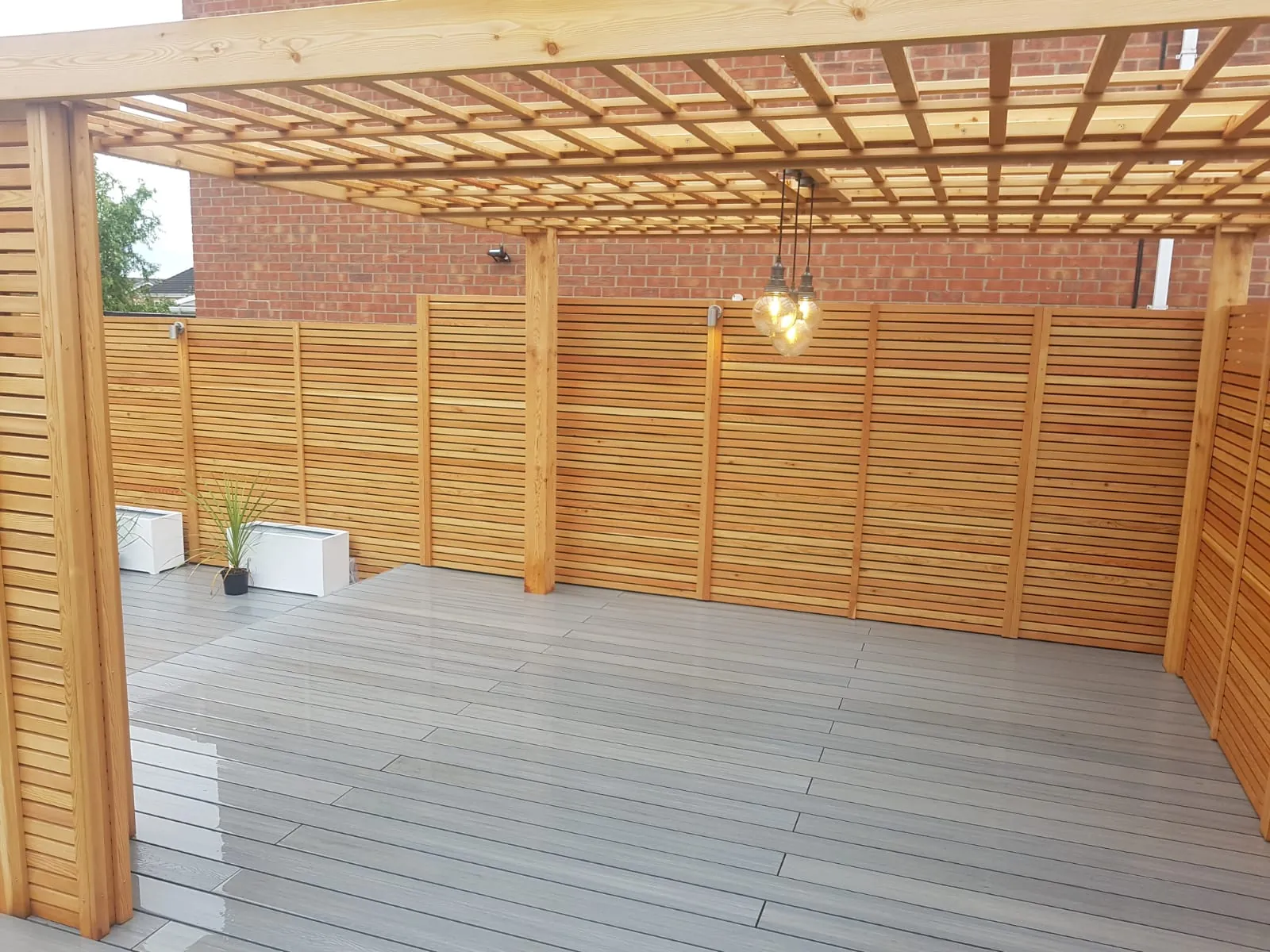 Composite decking under a timber pergola with slatted screens