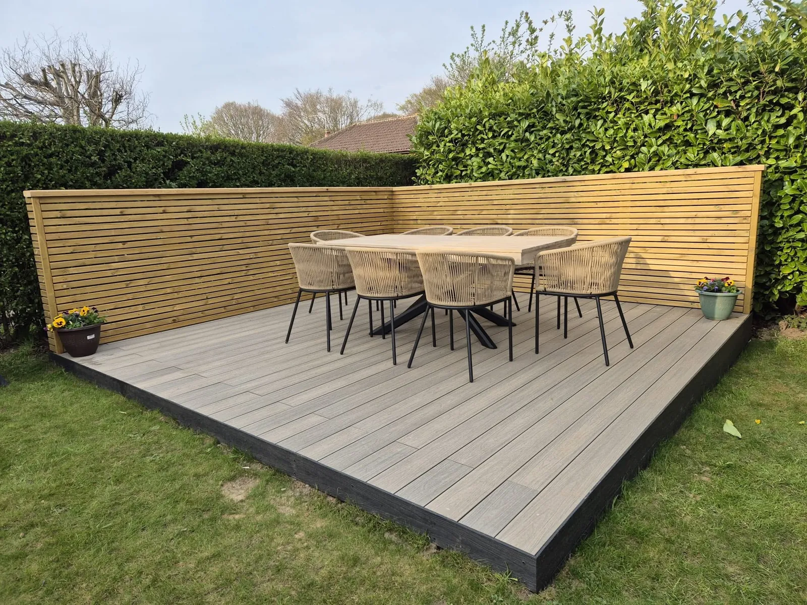 Raised composite decking with matching timber screen and dining area