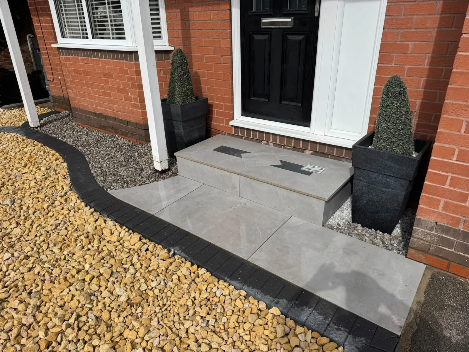 Front garden makeover with modern entrance steps, pale paving and gravel borders